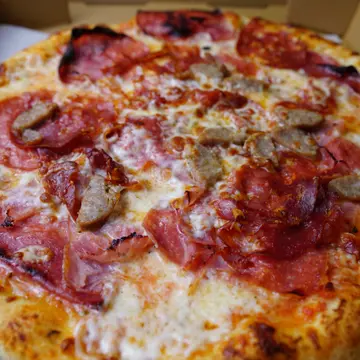 Meatlovers-style pizza from The Bus Pizza